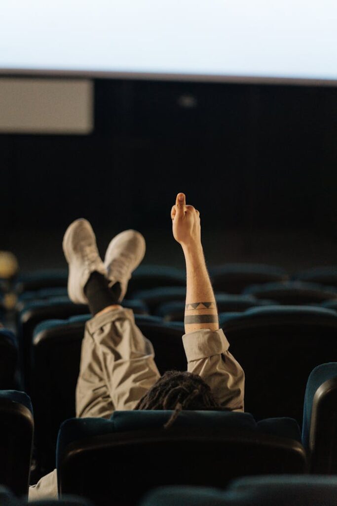 Person Sitting on a Chair and Feet on Top of the Seat